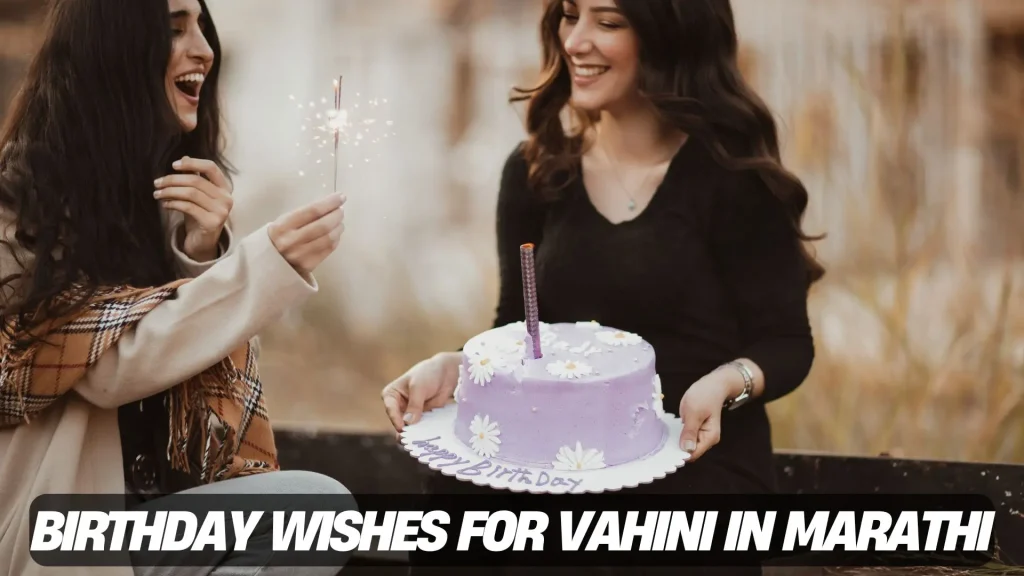 Two women celebrate a birthday with sparklers and a purple cake decorated with white flowers.